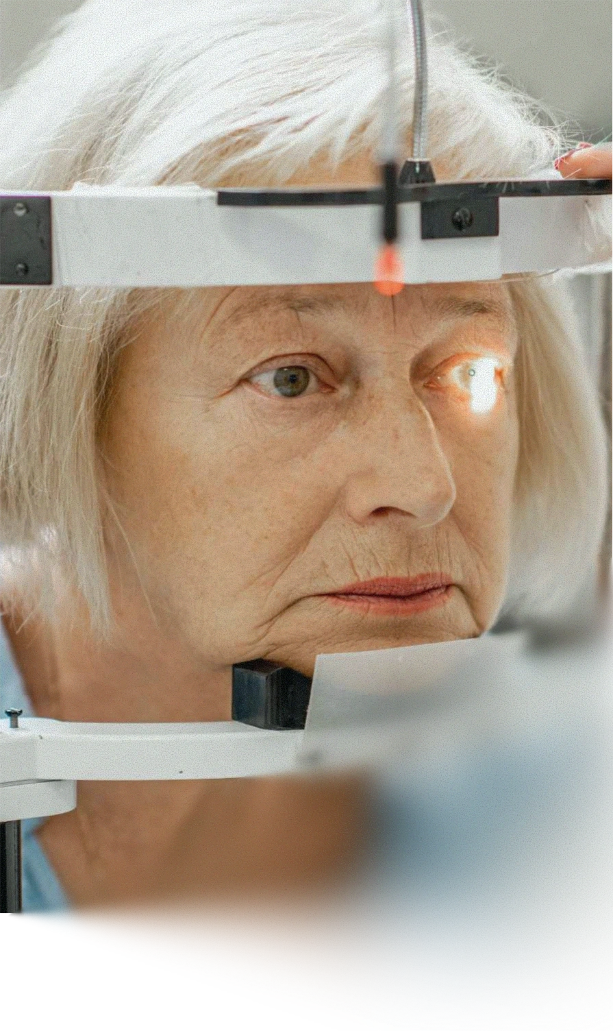 Person undergoing an eye examination using ophthalmic diagnostic equipment as part of vision assessment.