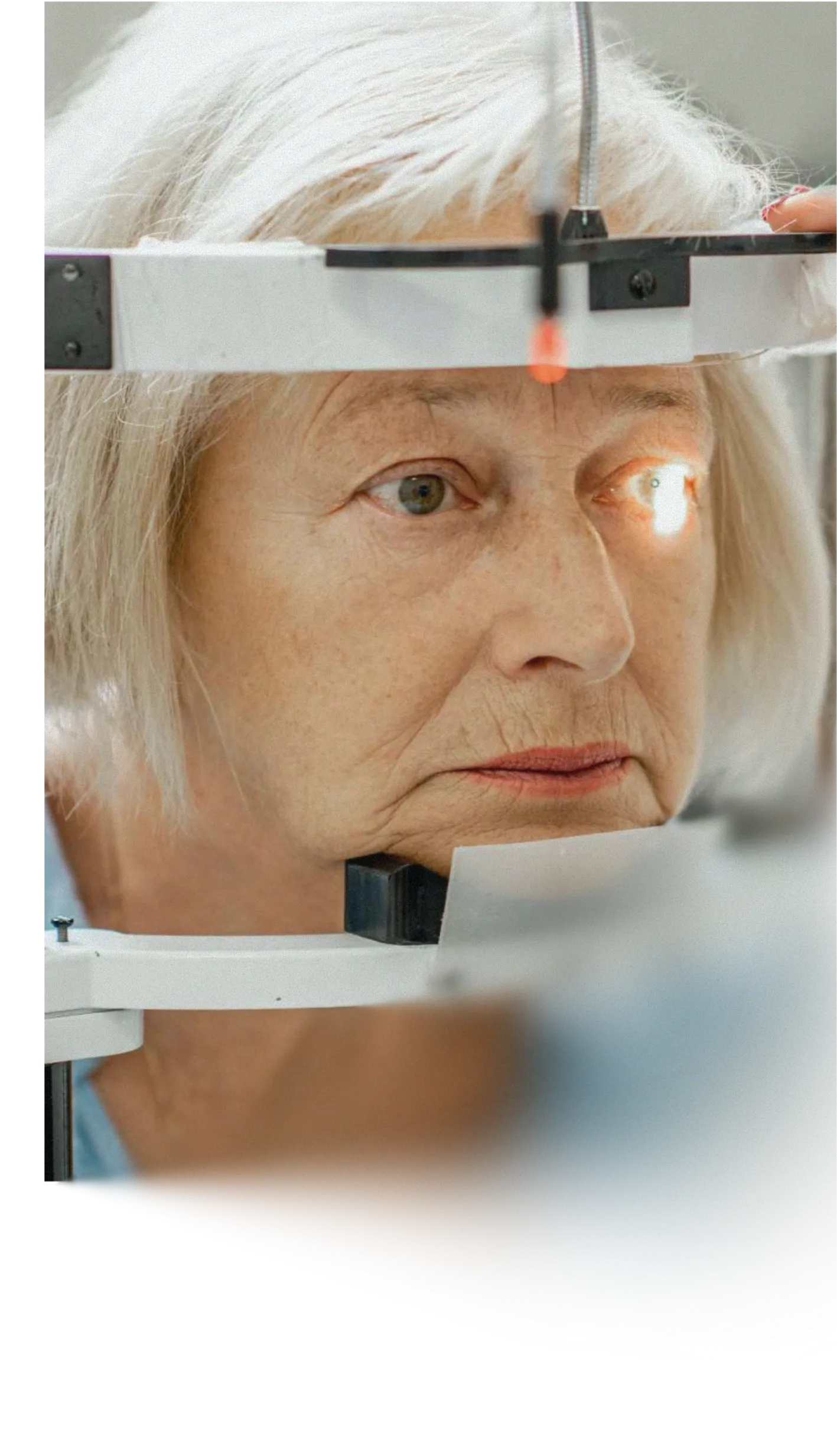 Person undergoing an eye examination using ophthalmic diagnostic equipment as part of vision assessment.